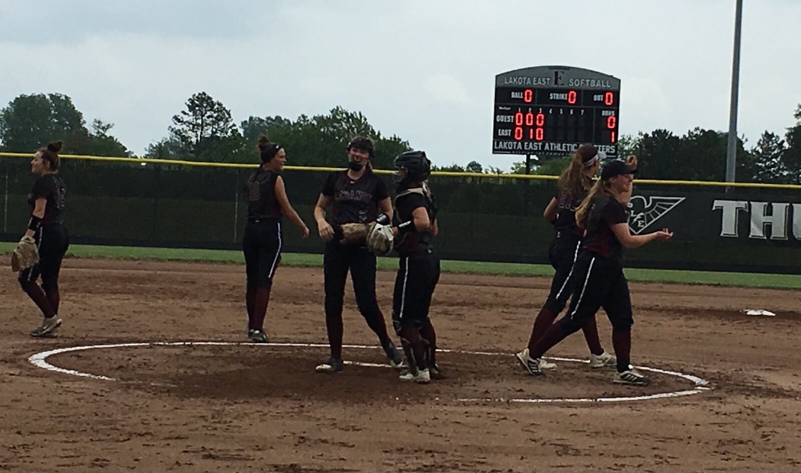 Lebanon pitcher Kat Frank and catcher Molly Osborne converse as an infield huddle breaks up during Saturday’s Division I district final against Fairfield at Lakota East. RICK CASSANO/STAFF