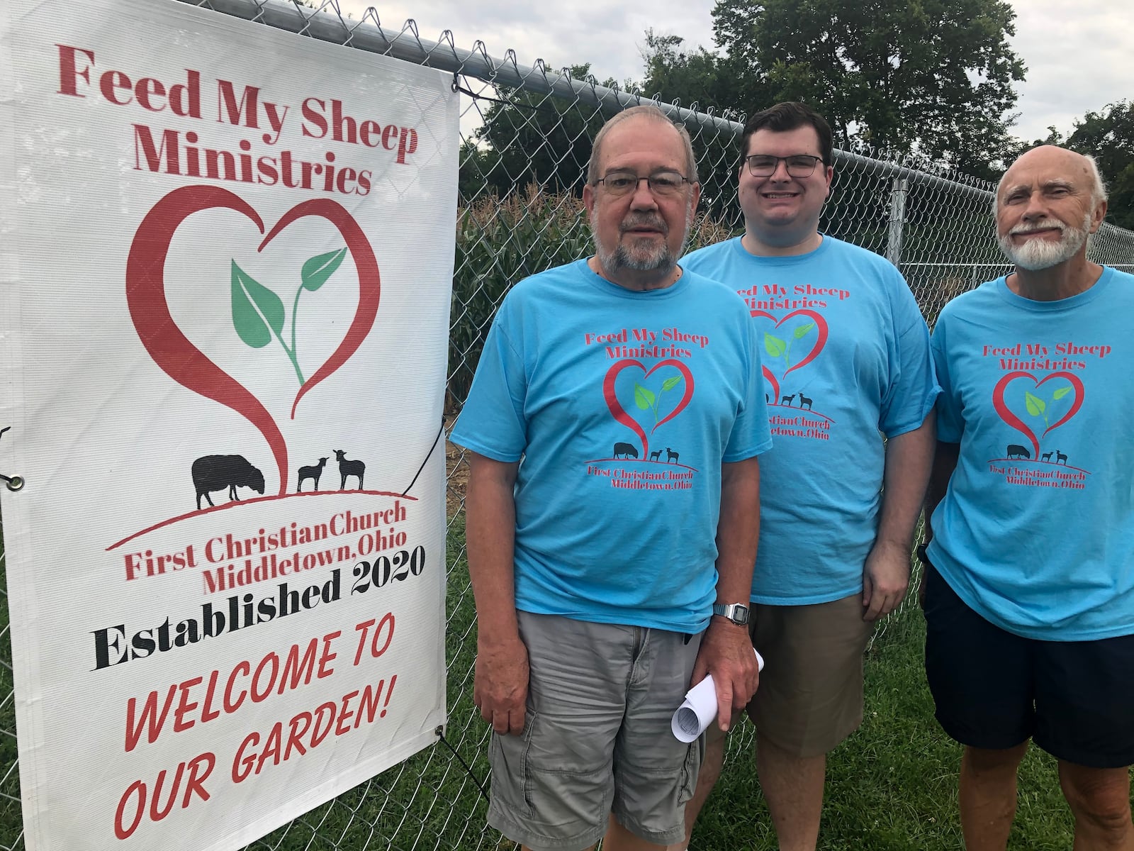 Larry Steele, from left, Pastor Connor Thompson and Dave Lombard stand outside the "Feed My Sheep Ministries" garden that opened at First Christian Church this year. RICK McCRABB/STAFF