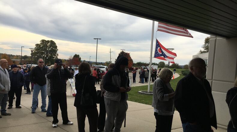 Some 197 people were waiting when early in-person voting began Sunday in Butler County, and eventually, a line stretched about a block outside the building with voters ready to register their opinions. Mike Rutledge/STAFF