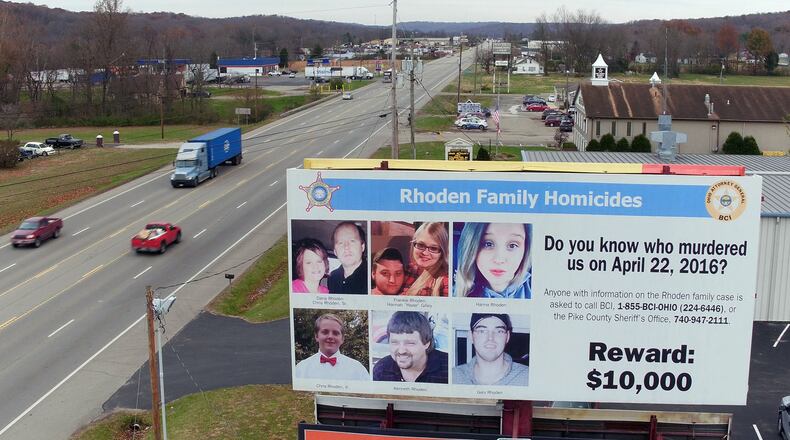 The reward billboard remains after arrests have been made in the Rhoden family slaying case that happened 2½ years ago, putting Pike County residents on edge. TY GREENLEES / STAFF