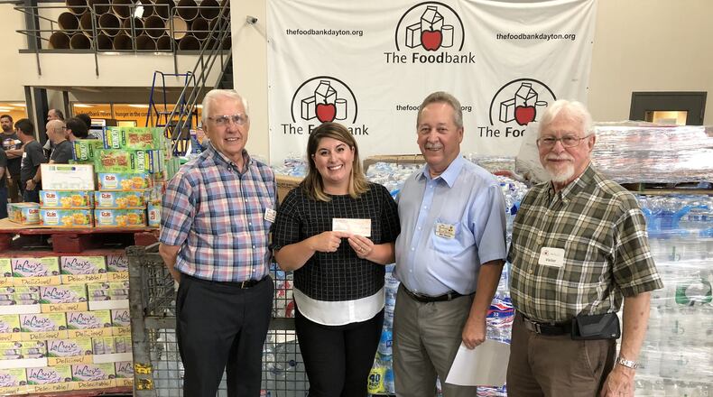 The Fairfield Food Pantry made a $1,000 donation weeks after the Memorial Day tornadoes that devastated the Miami Valley region. Pictured (from left to right) is Fairfield Food Pantry Secretary Dan Grabowski, The Dayton Foodbank Chief Development Officer Lee Truesdale, Fairfield Food Pantry trustee Bill Woeste, and and Carl Wriston, long-time friend of Nancye Greaser for whom the $1,000 donation was being given in honor. PROVIDED