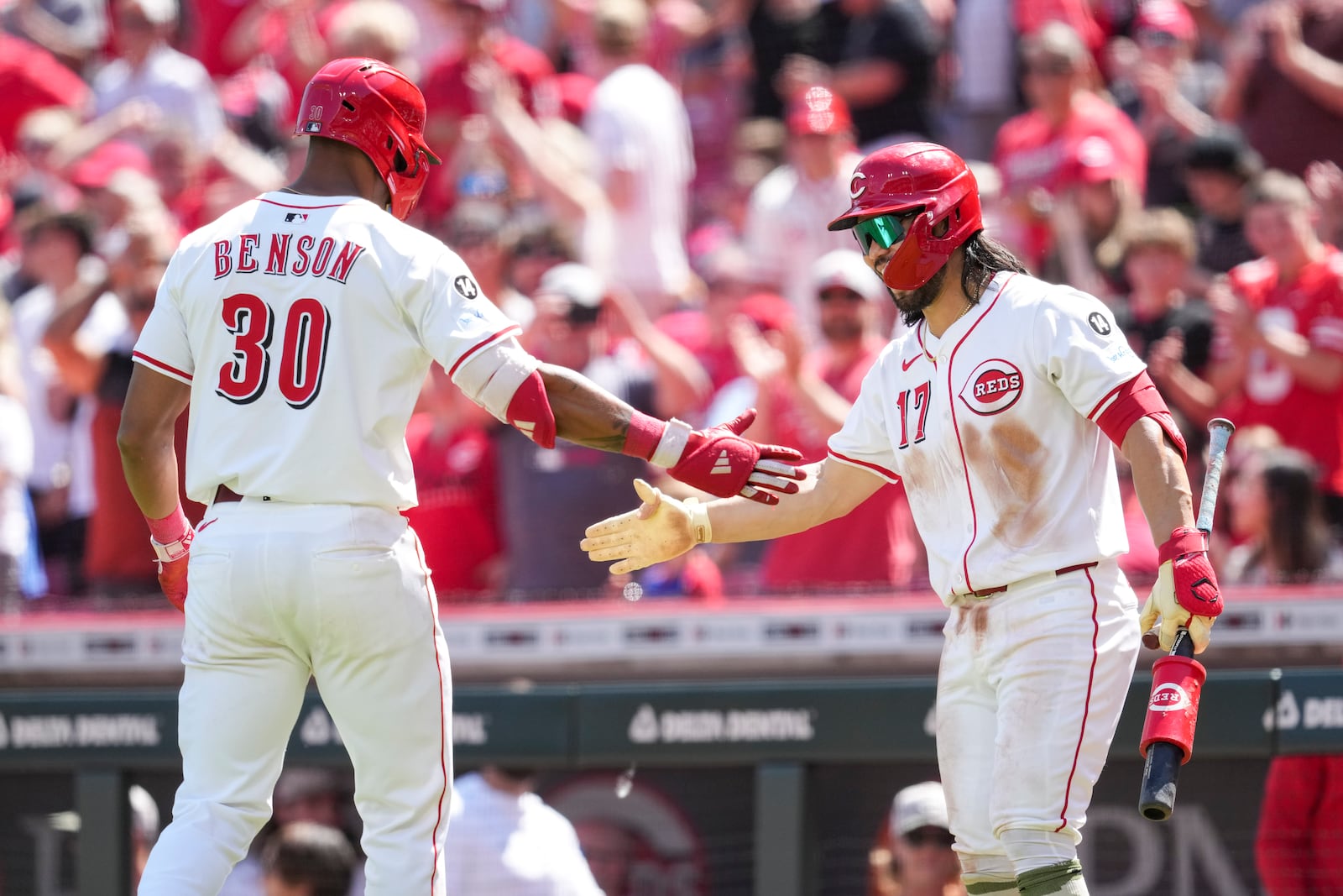 Cincinnati Reds' Will Benson (30) celebrates with teammate Connor Joe (17) after hitting a solo home run during the sixth inning of a baseball game against the Cleveland Guardians, Sunday, May 18, 2025, in Cincinnati. (AP Photo/Jeff Dean)