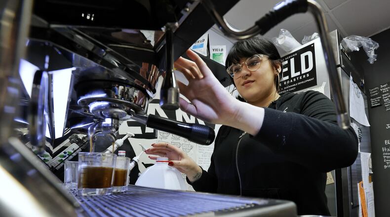 Samantha Wyatt makes a drink at Fringe Coffee Tuesday, Feb. 8, 2022 on High Street in Hamilton. NICK GRAHAM/STAFF