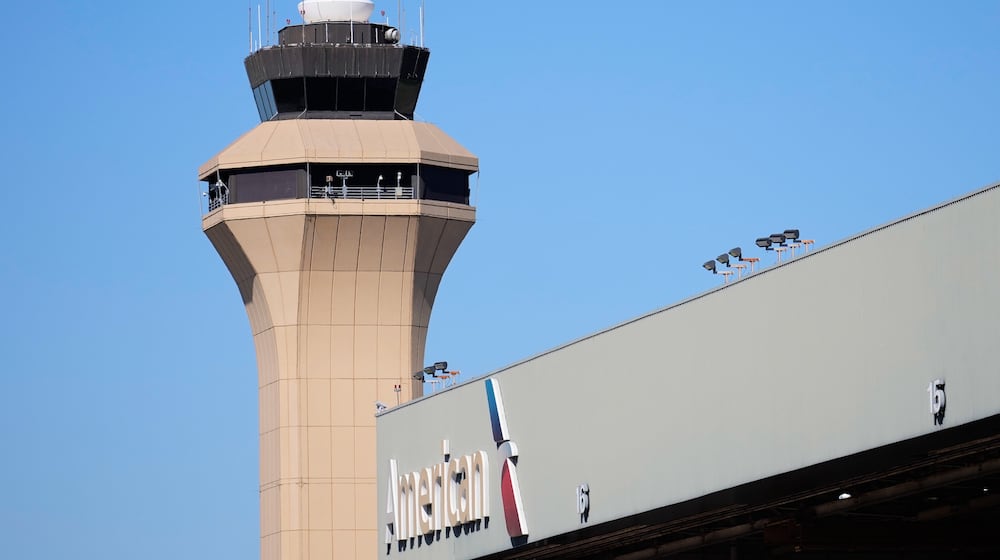 FILE - A control tower by an American Airlines hangar is shown at Dallas Fort Worth International Airport, Oct. 15, 2025, in DFW Airport, Texas. (AP Photo/Tony Gutierrez, file)