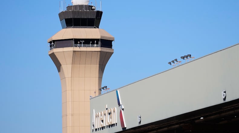 FILE - A control tower by an American Airlines hangar is shown at Dallas Fort Worth International Airport, Oct. 15, 2025, in DFW Airport, Texas. (AP Photo/Tony Gutierrez, file)