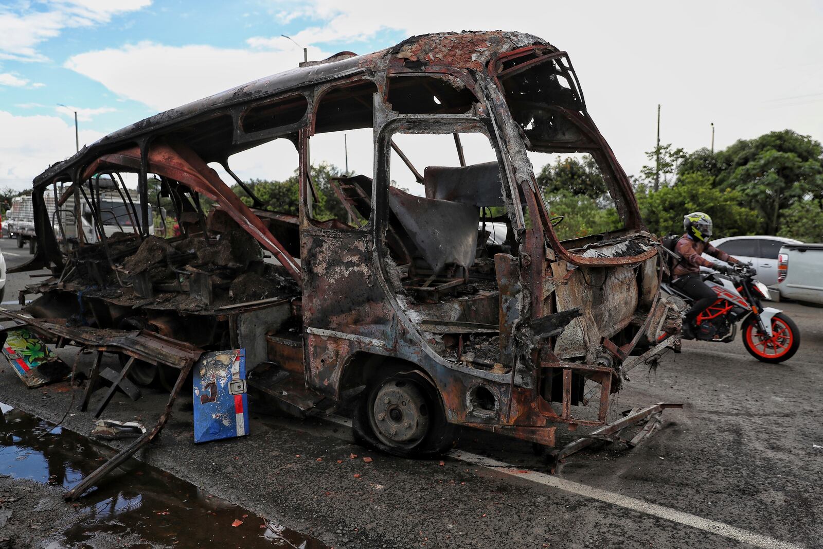 A bus that exploded next to a police station sits on a road in Villa Rica, Cauca Valley, Colombia, Tuesday, June 10, 2025. (AP Photo/Santiago Saldarriaga)
