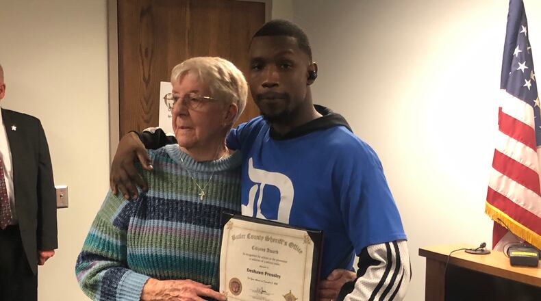 Deshawn Pressley, 27, of Middletown, received a "Citizens Award" from Butler County Sheriff Richard Jones Thursday. Pressley chased down a man who allegedly stole a purse belonging to Patricia Goins, 87, of Trenton, while they were shopping at Kroger on Oxford State Road. RICK McCRABB/STAFF