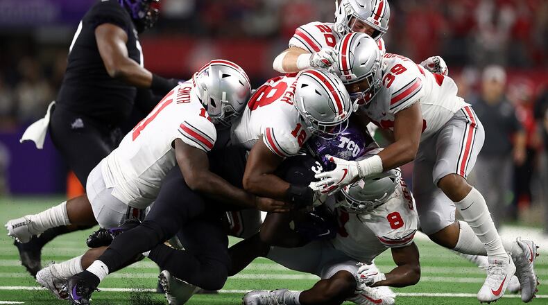 ARLINGTON, TX - SEPTEMBER 15: The Ohio State Buckeyes defense makes a tackle against Sewo Olonilua #33 of the TCU Horned Frogs in the third quarter during The AdvoCare Showdown at AT&T Stadium on September 15, 2018 in Arlington, Texas. (Photo by Ronald Martinez/Getty Images)
