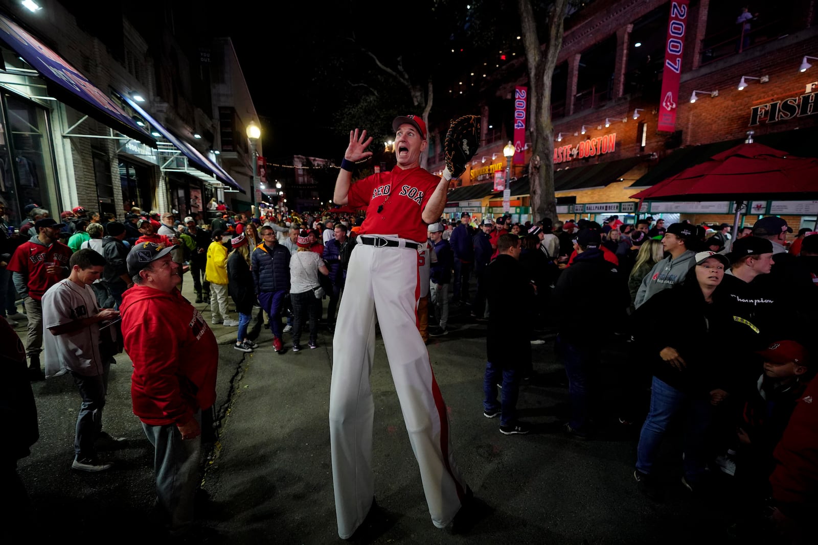 FILE-A street performer entertains the crowd outside Fenway Park in this Oct. 19, 2021 file photo in Boston.(AP Photo/Robert F. Bukaty, files)