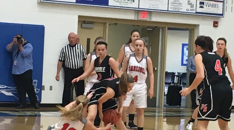 Carlisle’s Christa Harris (10) and Preble Shawnee’s Abby Bulach (11) battle for the ball Saturday during a Division III sectional game at Franklin Monroe. RICK CASSANO/STAFF