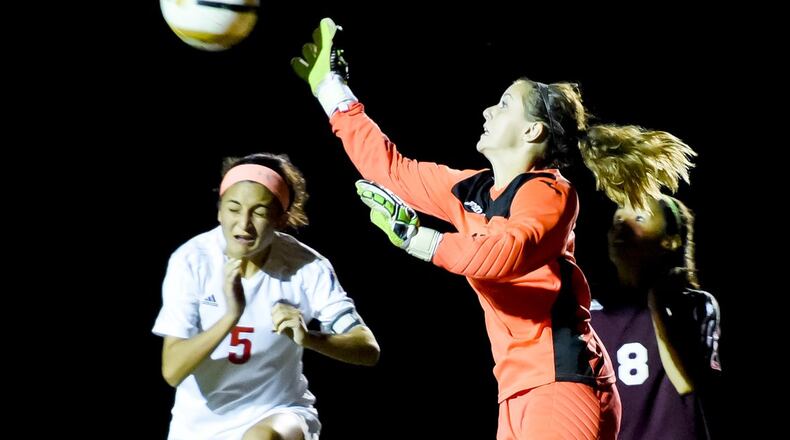 Ross goalkeeper Katie Hansen knocks away the ball as Fenwick’s Alisha Himes (5) runs in during their Division II sectional game on Oct. 22, 2015, at Fenwick. The visiting Rams won 2-0. NICK GRAHAM/STAFF