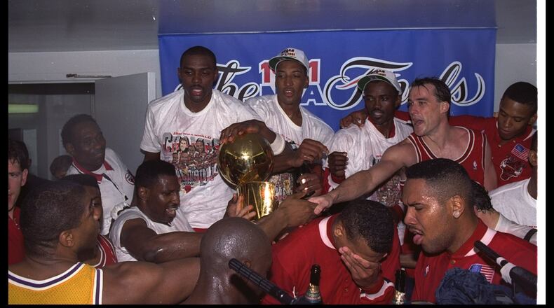 Jun 1991:  Guard Magic Johnson of the Los Angeles Lakers (bottom, left corner) shakes hands with guard John Paxton of the Chicago Bulls, right, as the Bulls celebrate after defeating the Los Angeles Lakers in the NBA finals at the Great Western Forum in I