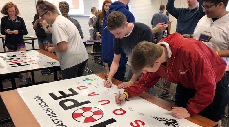 Lakota East High School students sign a Hope Squad banner last year to symbolize their commitment to offering hope to their peers who may be in distress. SUBMITTED PHOTO