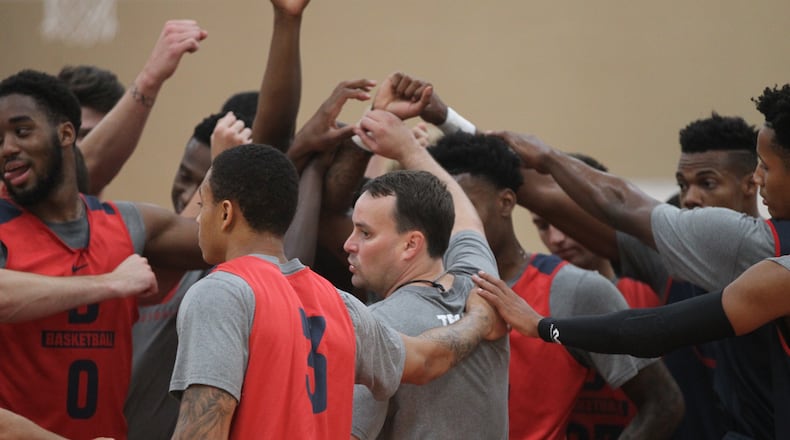 Dayton coach Archie Miller huddles with the team during practice on Thursday, Aug. 4, 2016, at the UD’s Cronin Center. David Jablonski/Staff