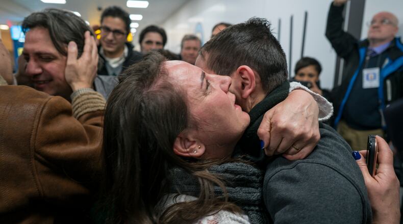 Family members who have just arrived from Syria embrace and are greeted by family who live in the United States upon their arrival at John F. Kennedy International Airport in New York, Monday, Feb. 6, 2017. (AP Photo/Craig Ruttle)