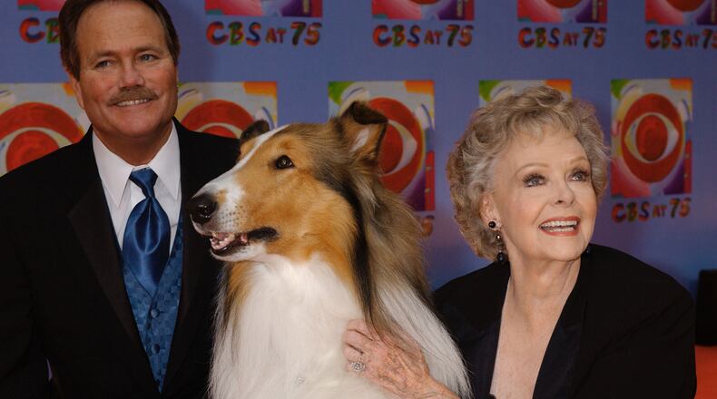 FILE - June Lockhart, right, who played the character of Ruth Martin, mother of Timmy Martin, played by Jon Provost, left, during the classic series "Lassie," poses for a photograph with Lassie, 9th generation, during arrivals at CBS's 75th anniversary celebration Sunday, Nov. 2, 2003, in New York. (AP Photo/Louis Lanzano, File)
