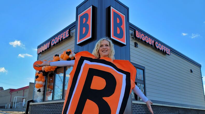 Butler County’s first Biggby Coffee shop is opening today in downtown Hamilton at 1055 High St. It will be the third location for franchisee’s Dustin and Amy Hepburn, who live in Loveland. Amy attended Monday's ribbon-cutting and wore her Biggby costume. NICK GRAHAM/STAFF
