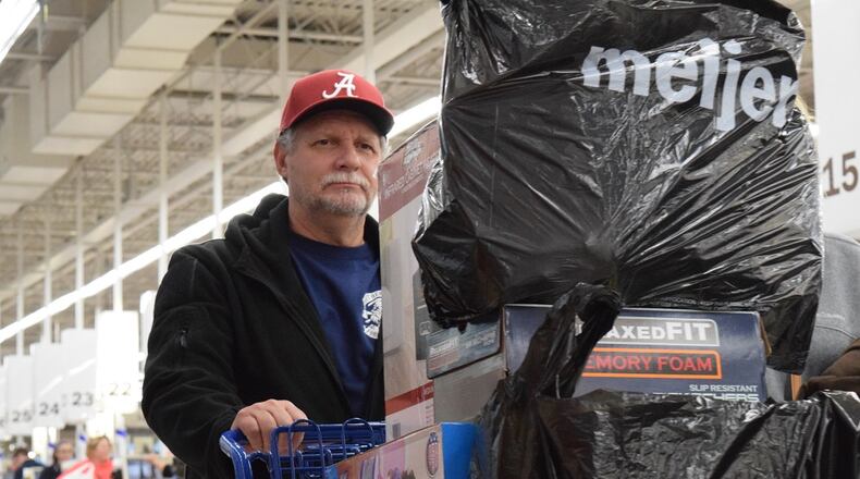 Hundreds of shoppers waited in lines at the Kettering Meijer on Thanksgiving, yet nationally, about 9 million fewer people shopped over the five-day Thanksgiving weekend. STAFF PHOTO / HOLLY SHIVELY