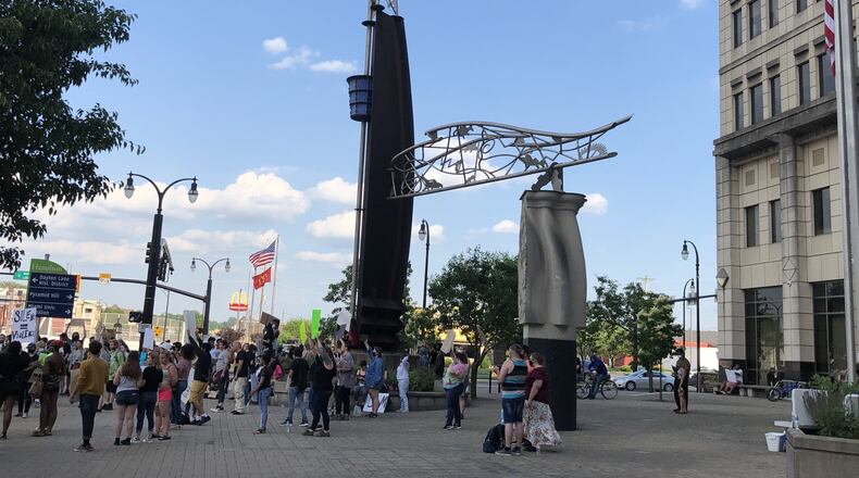 The Hamilton Gateway sculpture represents several things, including hopes for democracy and justice, the Great Miami River and Hamilton industries, and the depth of the river during the Great Flood of 1913. MIKE RUTLEDGE/STAFF
