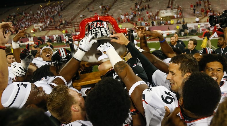 OXFORD, OH - SEPTEMBER 16: The Cincinnati Bearcats celebrate with the Victory Bell after defeating the Miami Ohio Redhawks 21-17 at Yager Stadium on September 16, 2017 in Oxford, Ohio. (Photo by Michael Reaves/Getty Images)