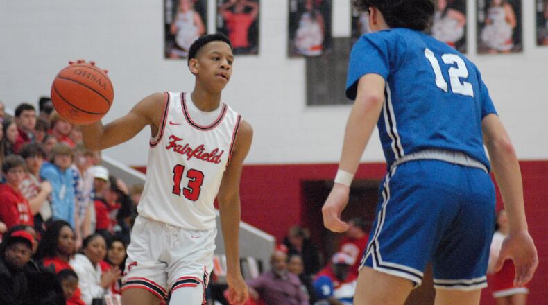 Fairfield sophomore Daviawne Crim (13) is guarded by Hamilton junior Clint Moak (12) during their game on Friday night at Fairfield Arena. Chris Vogt/CONTRIBUTED