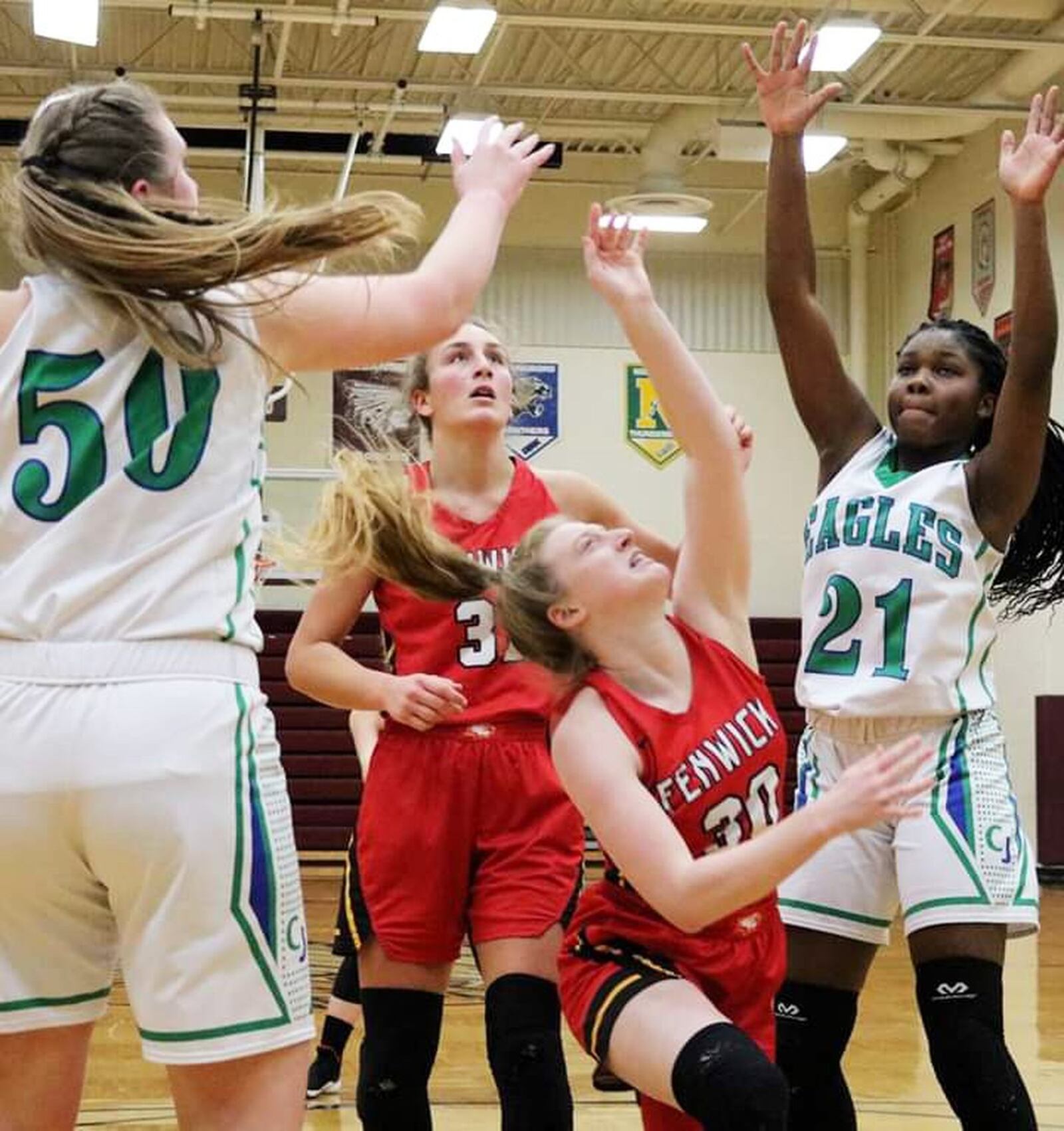 Fenwick’s Elena Daly (30) makes an off-balance shot in the lane as teammate Emily Adams (31) watches, along with Chaminade Julienne’s Eve Monaghan (50) and Jordyn Varise (21), during Saturday afternoon’s Division II sectional opener at Lebanon. Fenwick won 38-35. CONTRIBUTED PHOTO BY TERRI ADAMS