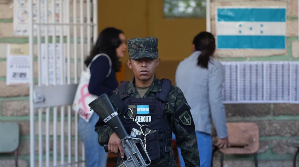 A soldier guards a polling station during general elections in Tegucigalpa, Honduras, Sunday, Nov. 30, 2025. (AP Photo/Moises Castillo)