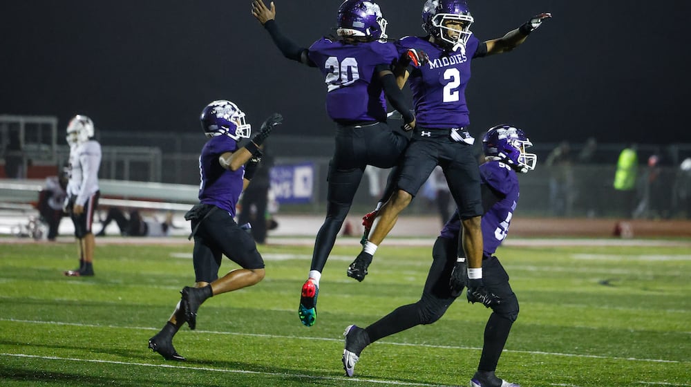 Middletown's Harlem Coleman (20) and Ace Cooper (2) celebrate their Division I Regional football final win against Wayne Friday, Nov. 21, 2025 at Trotwood Madison High School. Middletown won 21-14 to advance. NICK GRAHAM/STAFF