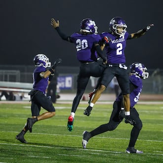 Middletown's Harlem Coleman (20) and Ace Cooper (2) celebrate their Division I Regional football final win against Wayne Friday, Nov. 21, 2025 at Trotwood Madison High School. Middletown won 21-14 to advance. NICK GRAHAM/STAFF