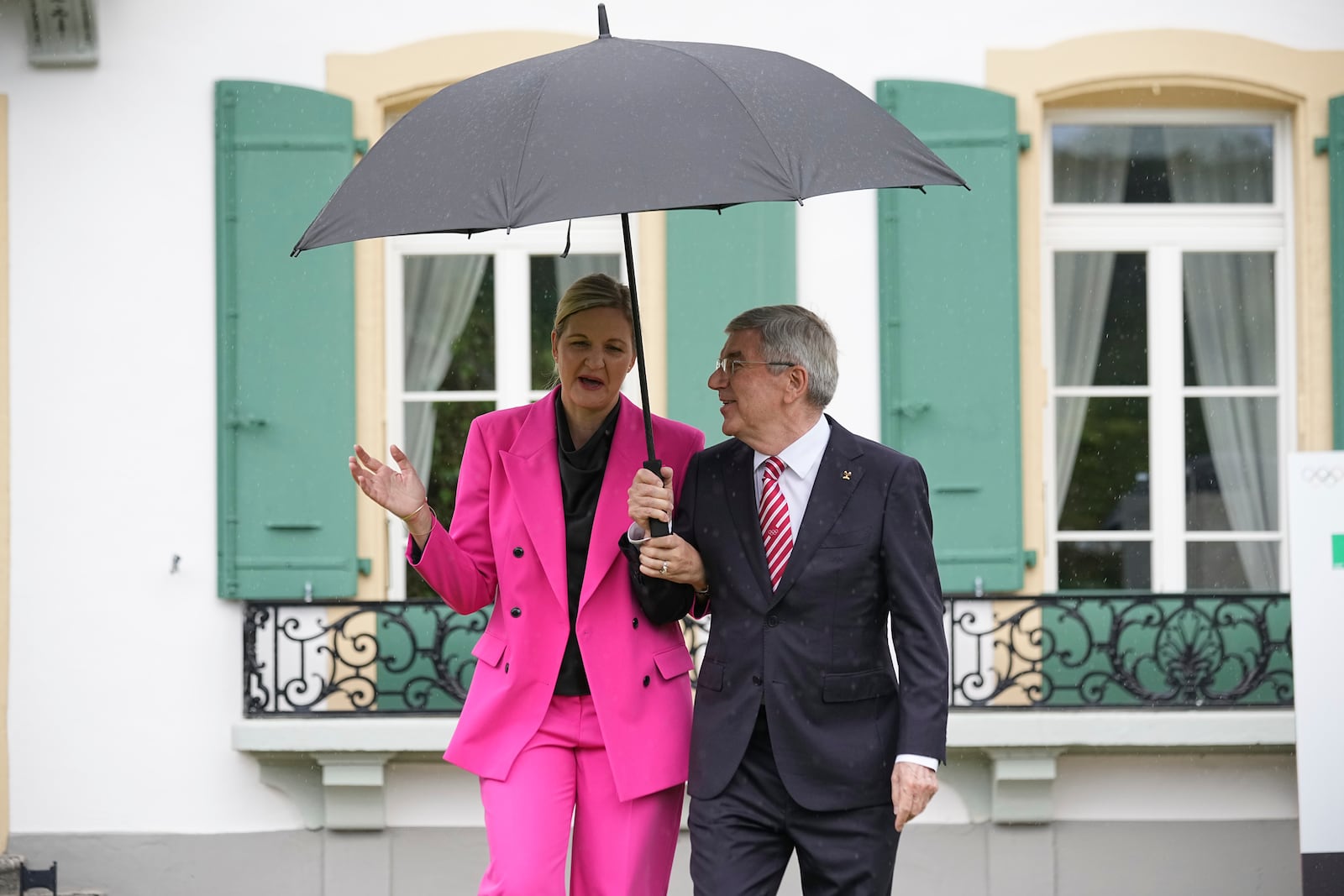 IOC President Thomas Bach, right, and President-elect Kirsty Coventry arrive for the handover ceremony of the IOC Presidency at Olympic House in Lausanne, Switzerland, Monday, June 23, 2025. (AP Photo/Laurent Cipriani)