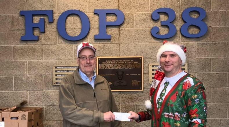 The Hamilton Fraternal Order of Police Lodge #38 conducted its annual Christmas Caravan on Saturday as officers from area police departments delivered gifts to needy families. Mayor Patrick Moeller (left) with Hamilton police Sgt. Brian Robinson just before a caravan of officers left to deliver the gifts. CONTRIBUTED