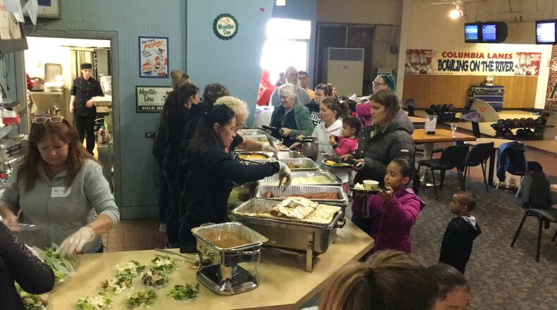 Riding for Turkeys annual Thanksgiving dinner on Sunday, Nov. 11, 2018, at Strikes at Columbia Lanes served hundreds of people in need around Butler County. Those who attended got a free meal, free bowling for the kids and food to take home. Children also got to take home a pair of gloves, a winter hat and coat, and each family received a turkey to take home. MICHAEL D. PITMAN/STAFF