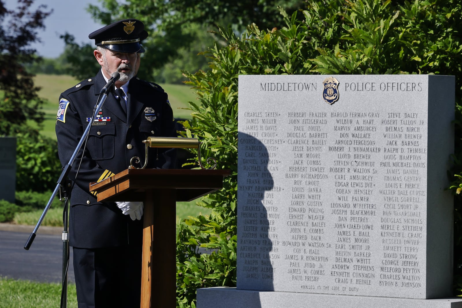 Middletown Deputy Police Chief Andy Warrick leads a memorial ceremony for fallen officers at Woodside Cemetery and Arboretum in Middletown. NICK GRAHAM/STAFF