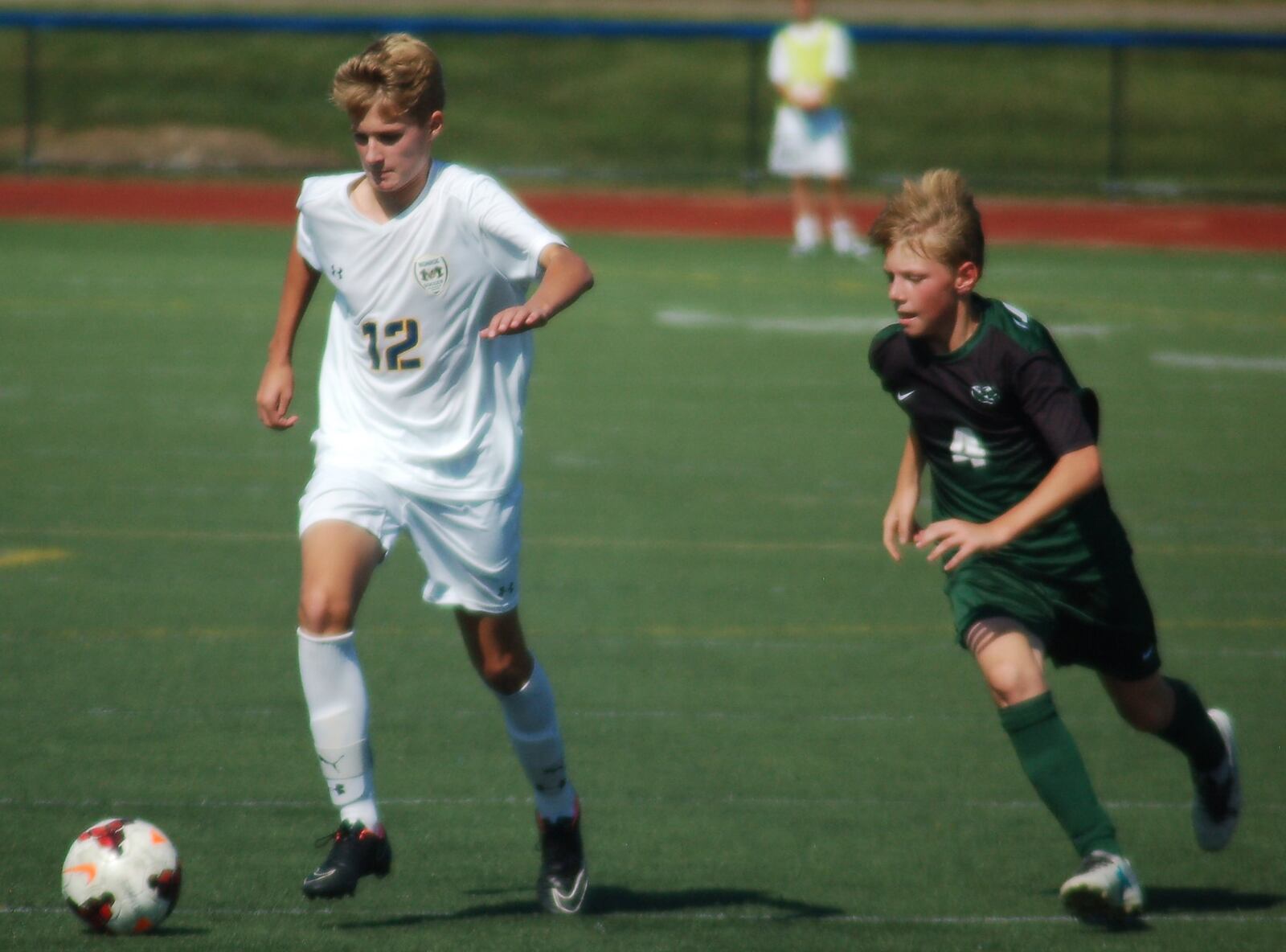 Monroe’s Ben Griffis takes the ball past Colby Stolph of Badin on Saturday afternoon at Monroe. CONTRIBUTED PHOTO BY JOHN CUMMINGS