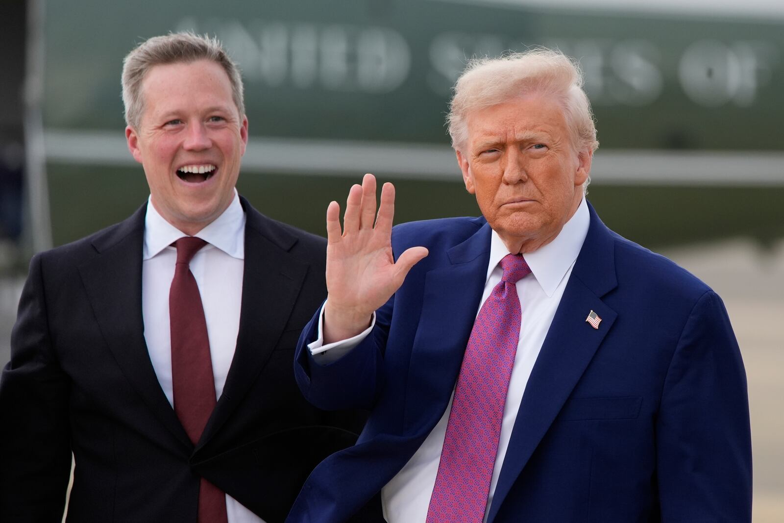 President Donald Trump waves as Secretary of the U.S. Army Daniel Driscoll watches at Pope Army Airfield at Fort Bragg, Tuesday, June 10, 2025, in Fort Bragg, N.C. (AP Photo/Alex Brandon)