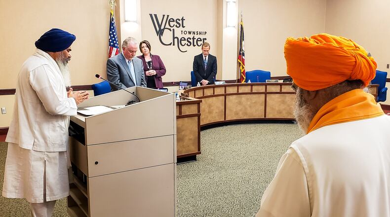 Amrik Singh, left, head priest of Guru Nanak Society of Greater Cincinnati, offered prayers for the Sikh community and those involved in the quadruple homicide last week during the West Chester Township trustees meeting Tuesday, May 7, 2019. NICK GRAHAM/STAFF