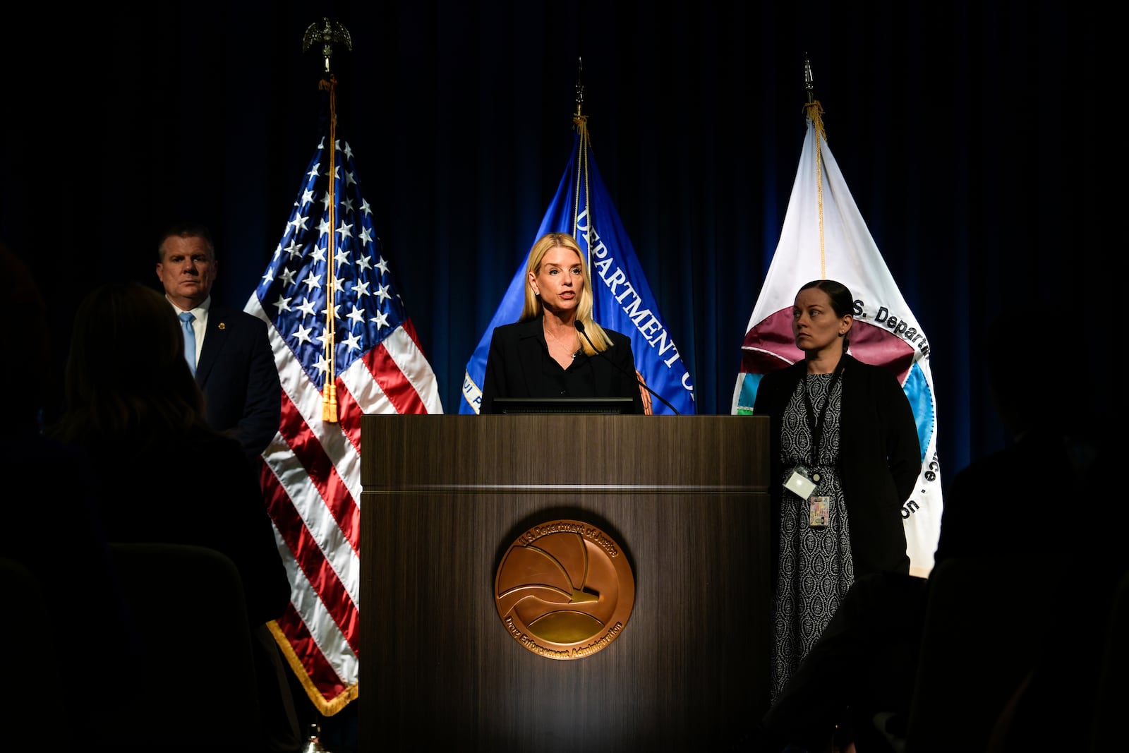 Attorney General Pam Bondi, center, speaks at a news conference at the Drug Enforcement Administration, Tuesday, July 15, 2025, in Arlington, Va. (AP Photo/Julia Demaree Nikhinson)