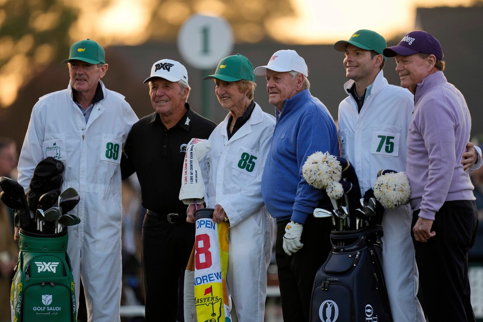From left: Honorary Starters Gary Player, Jack Nicklaus, and Tom Watson stand with their caddies as they pose on the first hole during the first round at the Masters golf tournament, Thursday, April 10, 2025, in Augusta, Ga. (AP Photo/David J. Phillip)