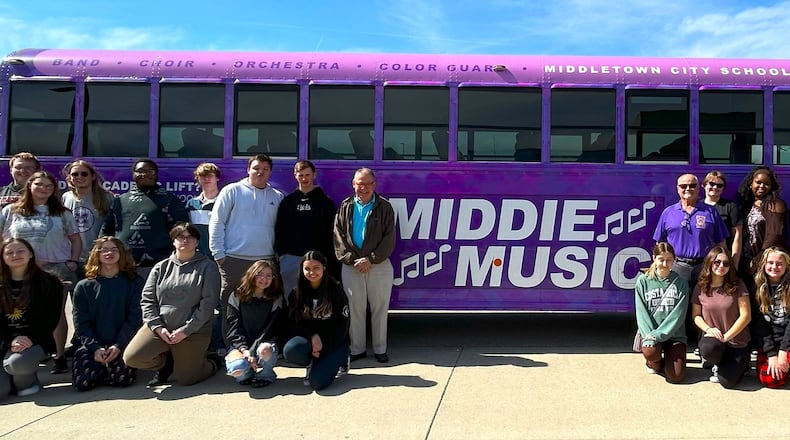 Middletown High School’s Marching Middie band, and other performing arts students from the school, will now be traveling in style in the school system’s first, decorated, dedicated school bus to transport students to football games, band contests and other performances. The colorful bus doubles as a rolling advertisement for district’s music programs. Pictured are some marching band students, performance arts teachers and others at a recent unveiling of the bus. CONTRIBUTED