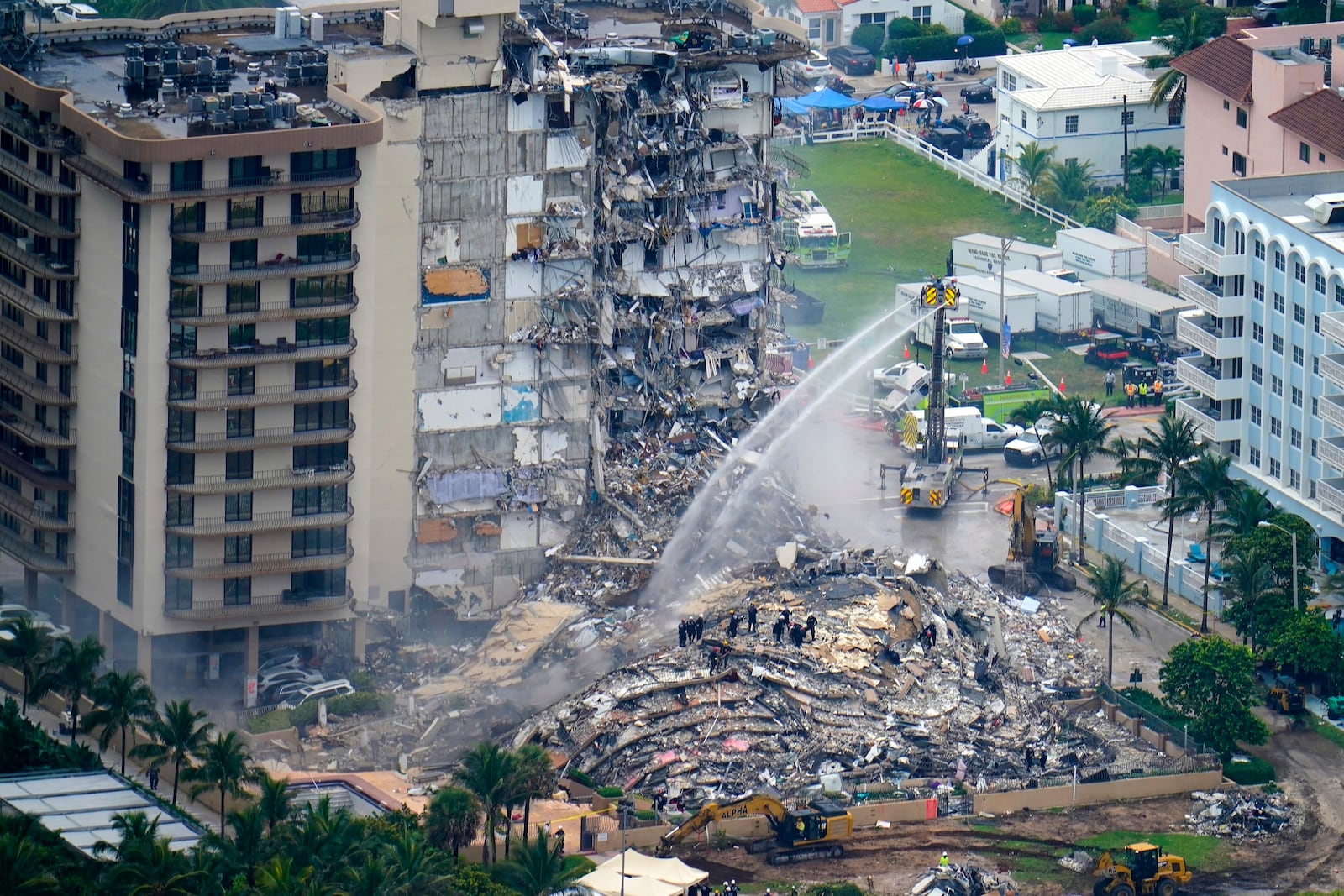 FILE - Rescue personnel work at the remains of the Champlain Towers South condo building, June 25, 2021, in Surfside, Fla. (AP Photo/Gerald Herbert, File)