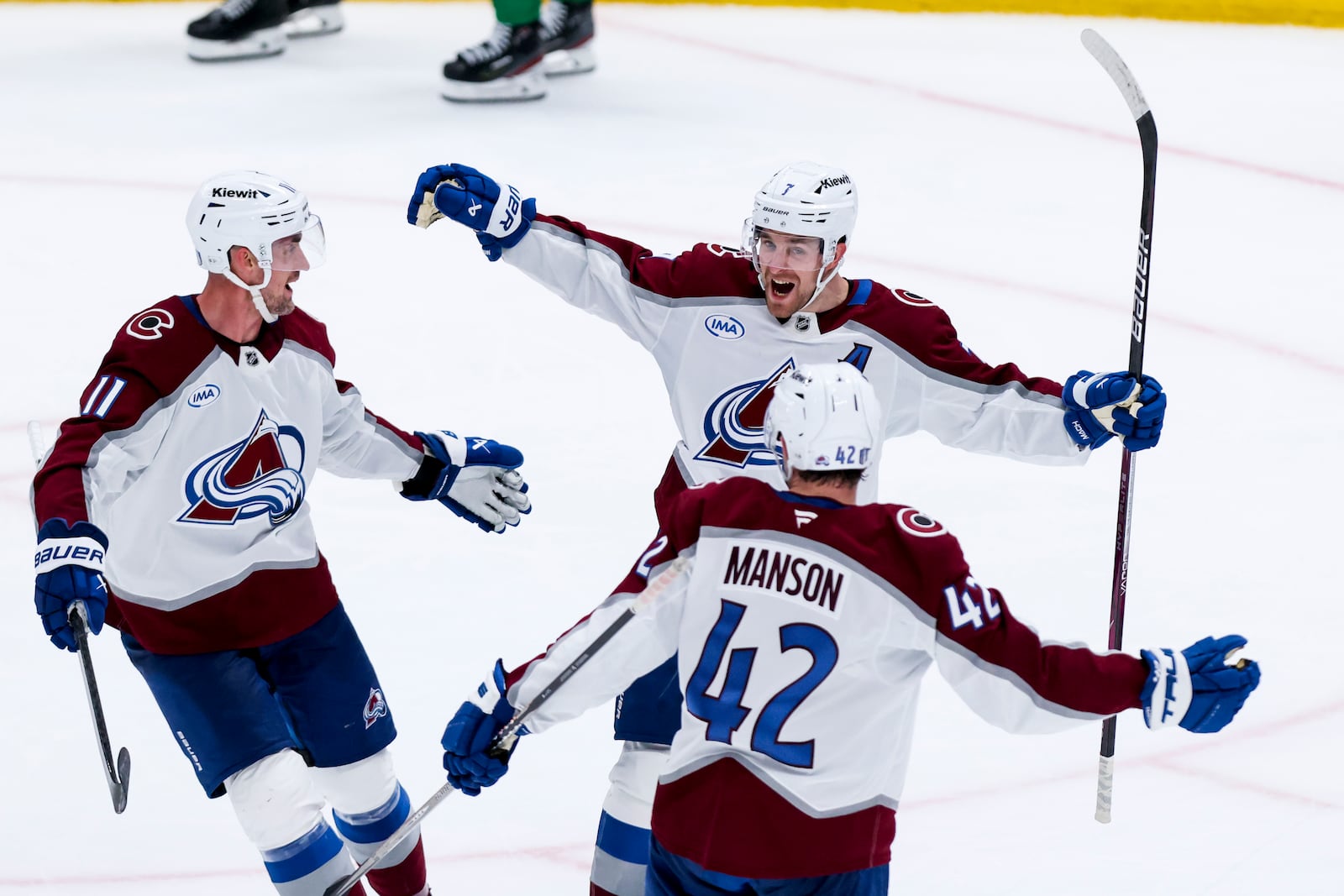 Colorado Avalanche players Brock Nelson (11), Devon Toews (7), and Josh Manson (42) celebrate after Toews' scored during a first-round NHL hockey playoff game against the Dallas Stars in Dallas, Saturday, April 19, 2025. (AP Photo/Gareth Patterson)