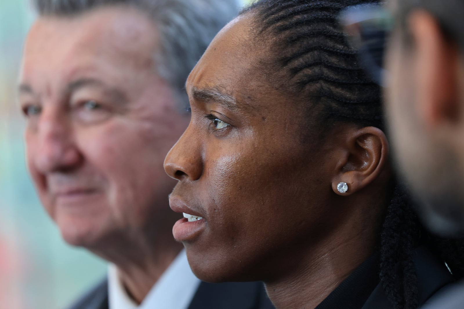 South Africa's Caster Semenya, center, answers reporters with lawyer Gregory Nott, left, after Semenya won a partial victory at the European Court of Human Rights on in her seven-year legal fight against track and field's sex eligibility rules, Thursday, July 10, 2025 in Strasbourg, eastern France. (AP Photo/Antonin Utz)