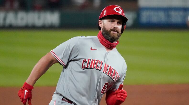 Cincinnati Reds' Matt Davidson (64) rounds the bases after hitting a grand slam during the sixth inning of a baseball game against the St. Louis Cardinals Friday, Aug. 21, 2020, in St. Louis. (AP Photo/Jeff Roberson)