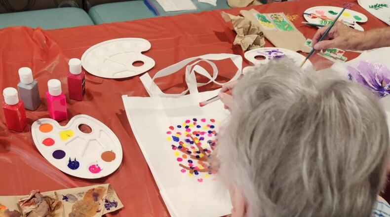 A resident of the Traditions of Beavercreek participates in one of the many group activities designed to stimulate the mind. SUBMITTED