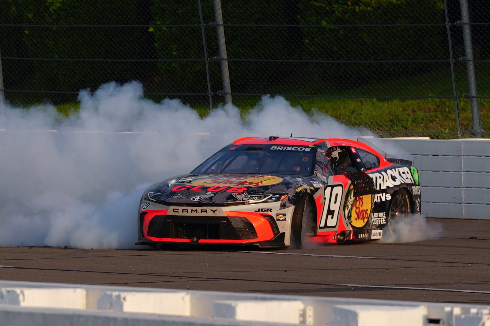 Chase Briscoe celebrates with a burnout after winning a NASCAR Cup Series auto race at Pocono Raceway, Sunday, June 22, 2025, in Long Pond, Pa. (AP Photo/Derik Hamilton)