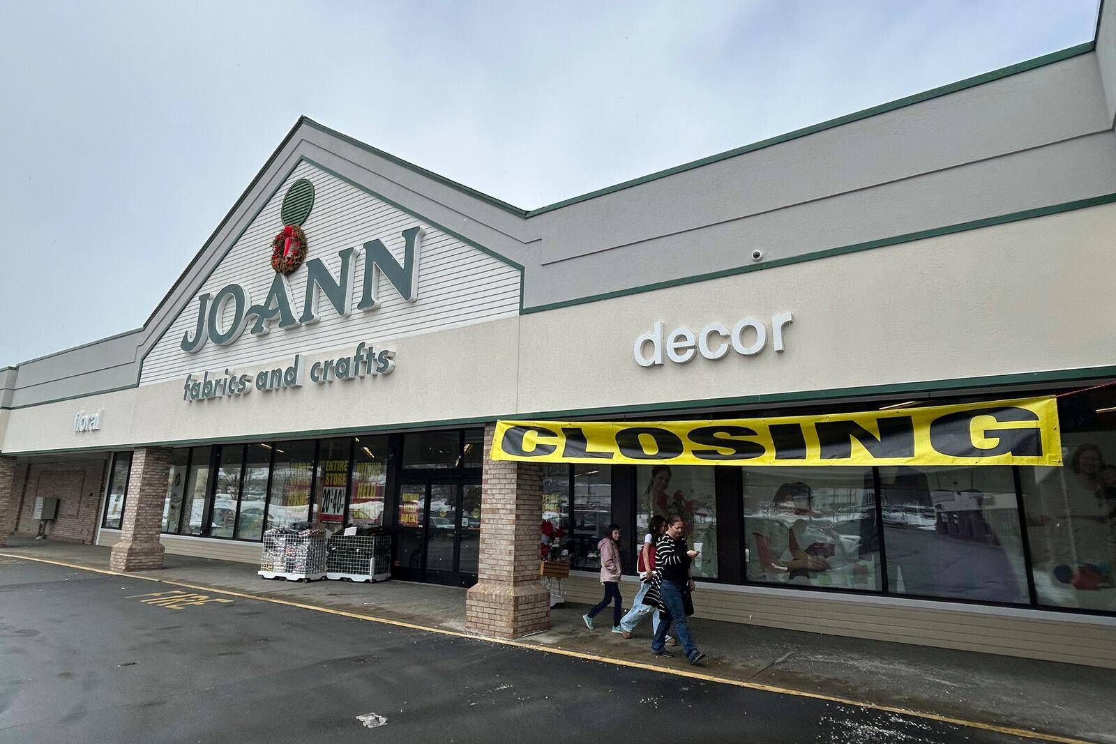 People exit a Joann Fabric and Crafts store in Barre, Vt., on Saturday, March 8, 2025. (AP Photo/Carolyn Lessard)
