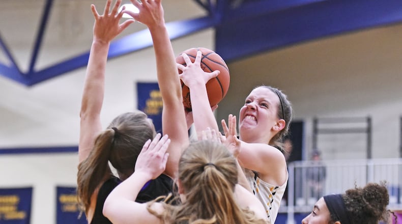 Monroe’s Sophie Sloneker puts up a shot over a group of Bellbrook defenders during their game Jan. 26, 2017, at Monroe. NICK GRAHAM/STAFF