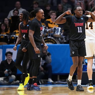 Howard guard Ose Okojie (11), center, reacts after scoring and drawing a foul during the first half in a First Four college basketball game in the NCAA Tournament against UMBC, Tuesday, March 17, 2026, in Dayton, Ohio. (AP Photo/Kareem Elgazzar)