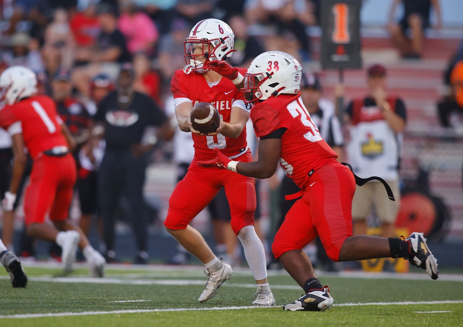 Fairfield's Dominic Back hands the ball off to Corrious Booker during their football game against Lakota West Friday, Sept. 19, 2025 in Fairfield. The Indians won 10-7. NICK GRAHAM/STAFF