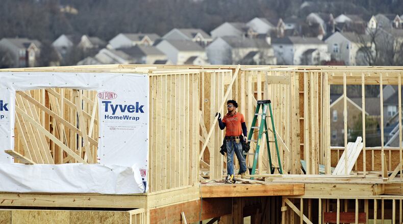 A crew works on construction of a new home on Elm Leaf Trail Monday, Feb. 20 in Liberty Township. NICK GRAHAM/STAFF